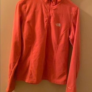 This is a coral colored North Face jacket
